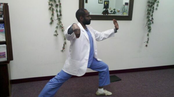 Performing Single Whip, a Tai Chi movement